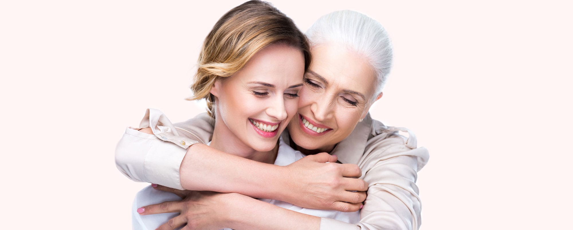 stock photo of a young woman being hugged by an older woman, presumably a relative